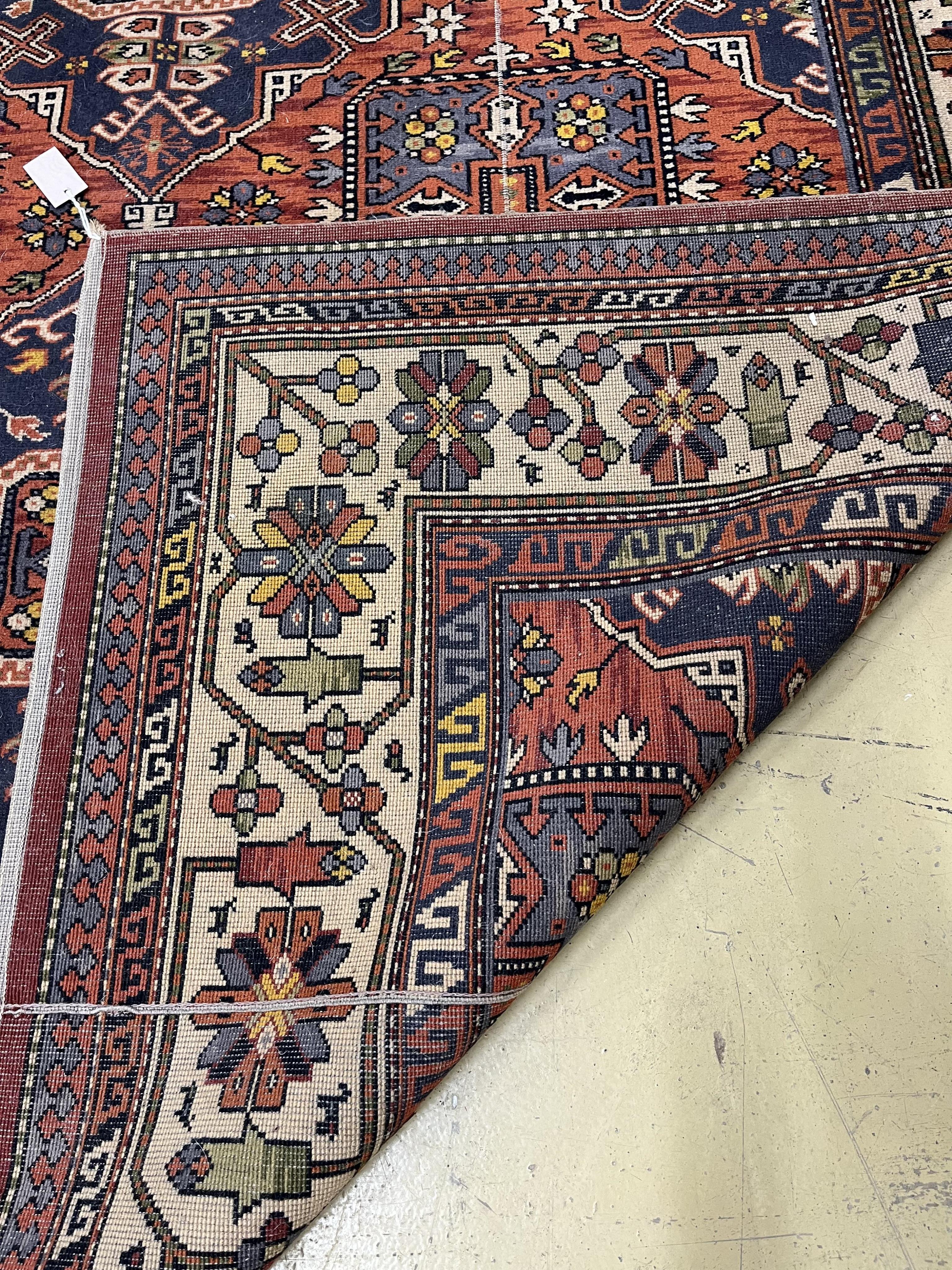 A Caucasian style red ground machined carpet, 275 x 192cm. Condition - poor